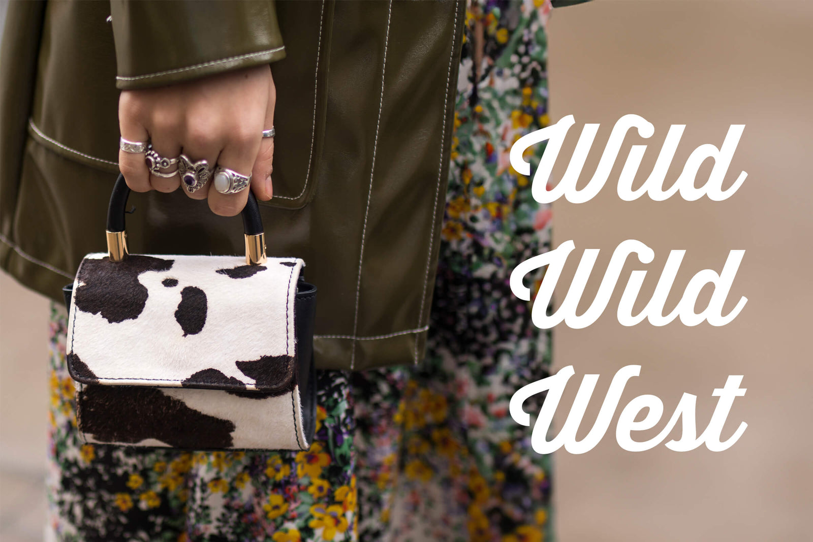 CND Fall Guide 2025 for Wild Wild West Nail Art. Person holding a cow print handbag with text 'Wild Wild West' on a neutral background