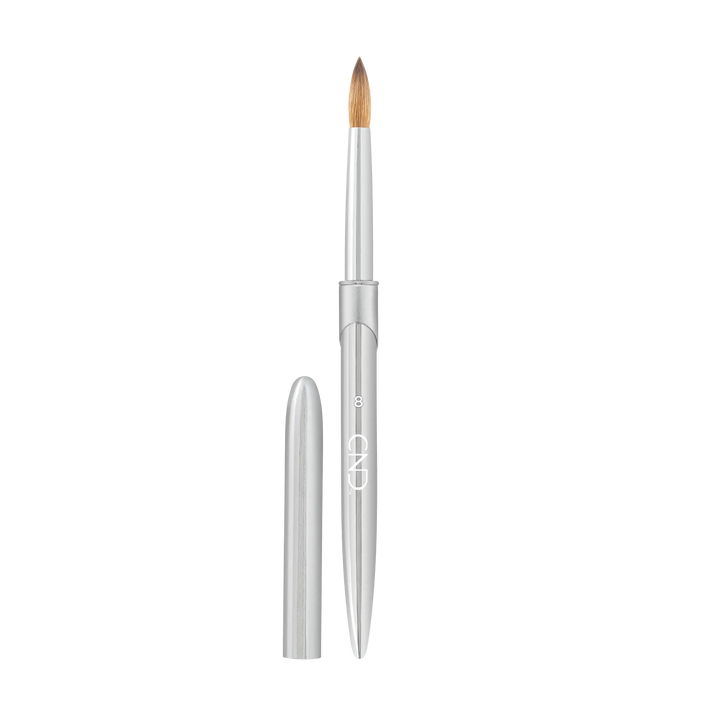 Pro Sculpting Liquid & Powder Round Brush #8 next to cap. Aluminum nail art brush with a rounded tip for application.