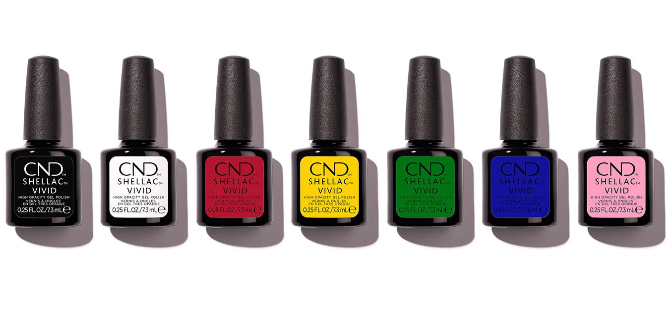 Lineup of CND SHELLAC VIVID Bottles. From Left to RIght, Black Tuxedo, White Gloves, Red Carpet, Yellow Taxi, Shamrock Green, Lazuli Blue, and Blush Pink.