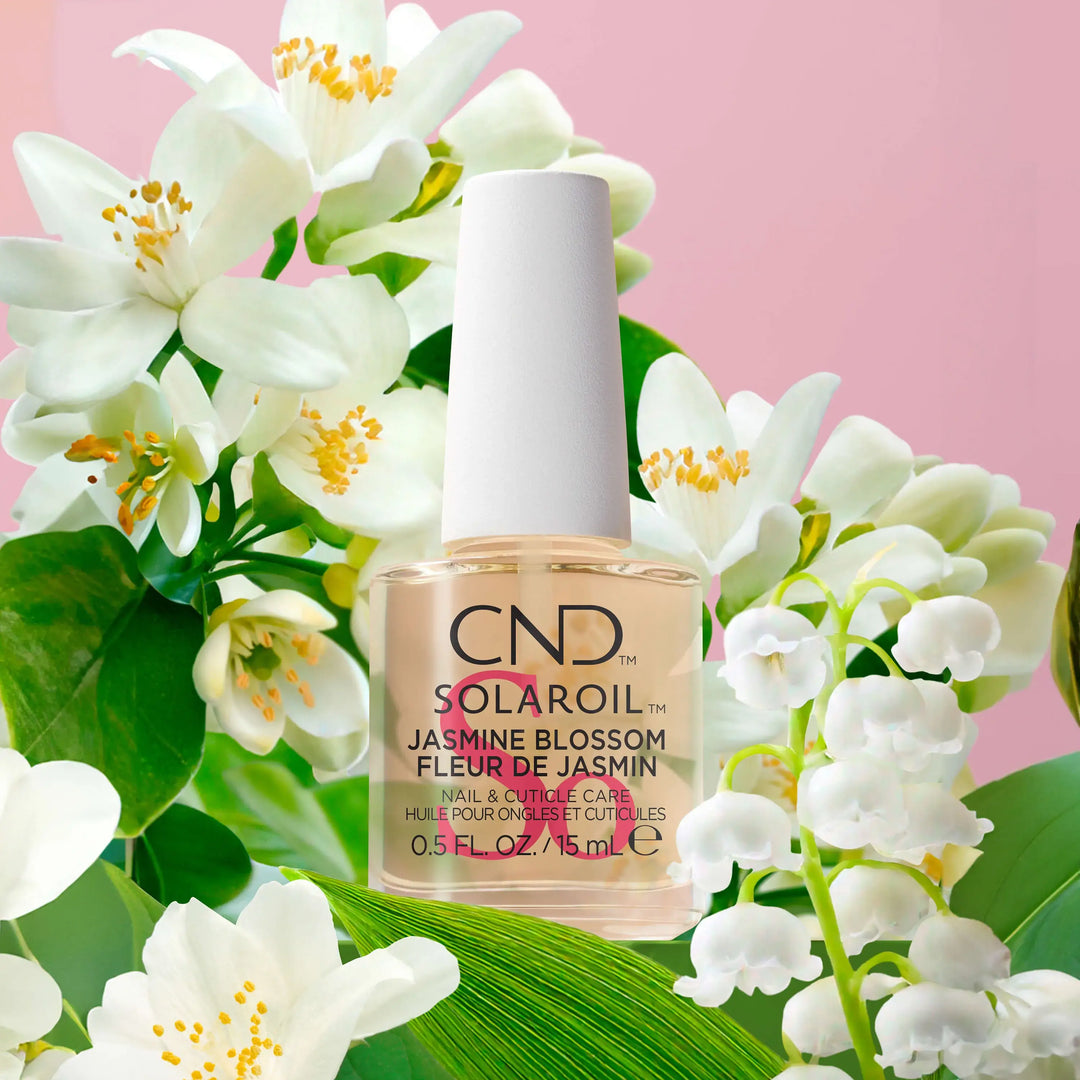 A small bottle of CND SolarOil with a brush applicator