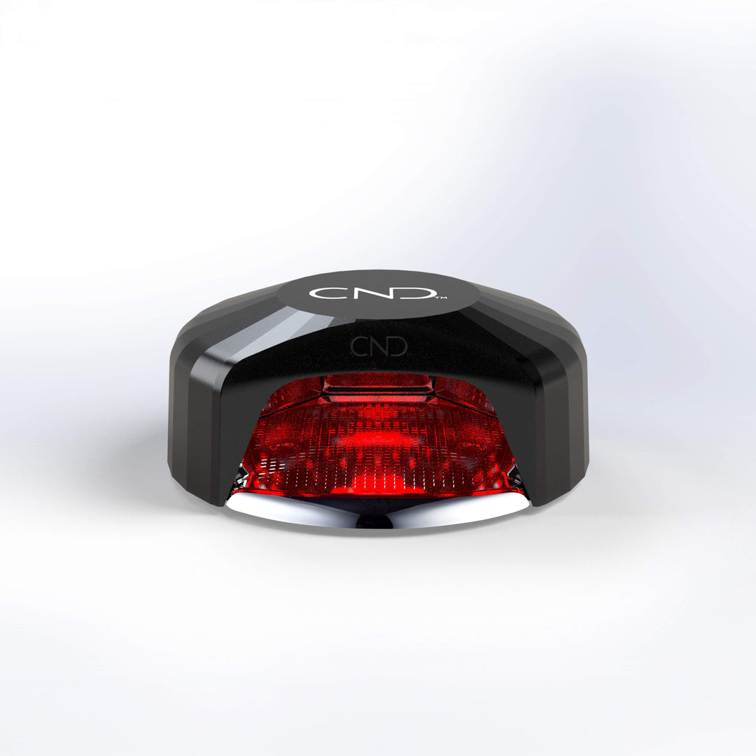 Black and red LED nail lamp light on a white background