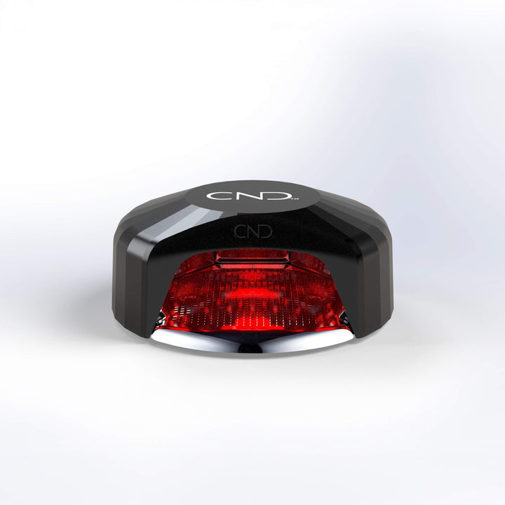 Black and red LED nail lamp light on a white background