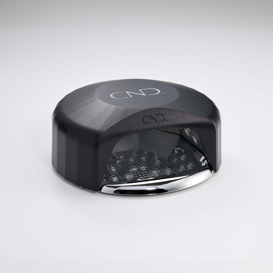Powered down black nail lamp with CND logo on a white background