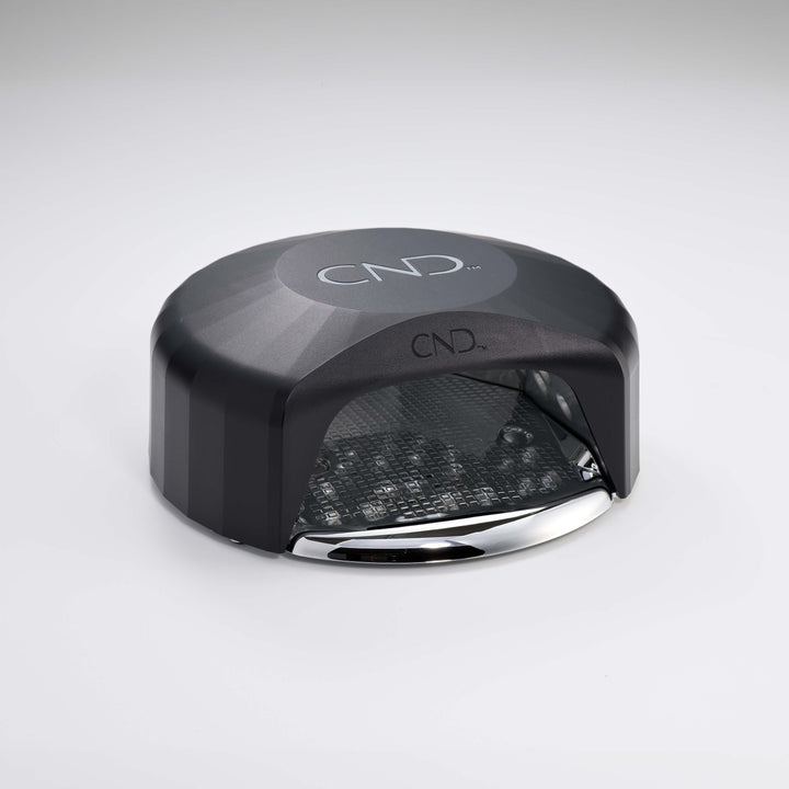 Powered down black nail lamp with CND logo on a white background