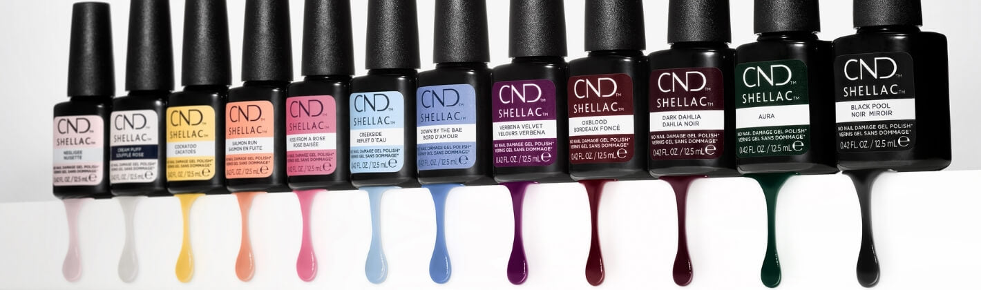 Row of CND SHELLAC nail polish bottles in various colors.