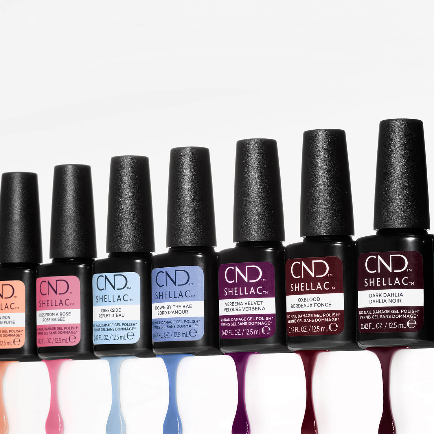 Row of CND Shellac nail polish bottles on a white background