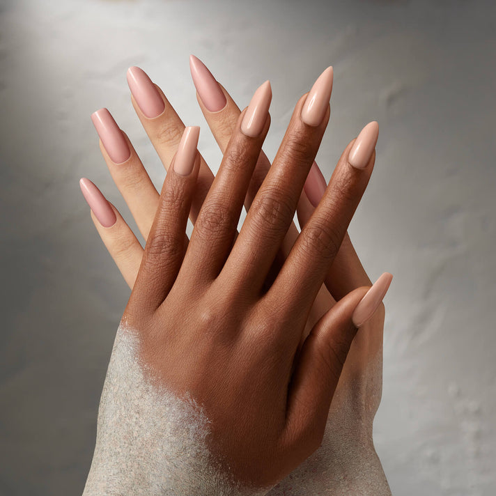 Close-up of manicured hands with Odorless Liquid & Powder to beige nail polish against a neutral background