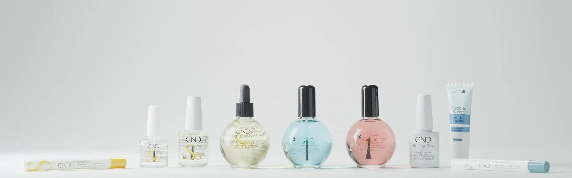 A row of popular CND Treatments including SolarOil Pen, SolarOil bottles, Stickey, Super Shiney, RescueRXx, and Cuticle Oil on a light gray background