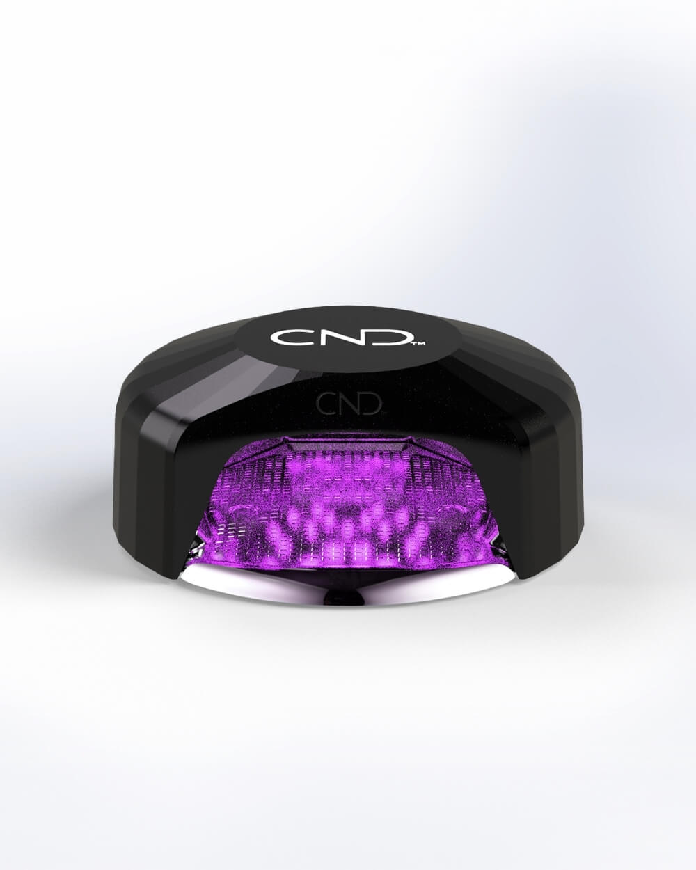 CND Visible Light Nail Lamp turned on with purple LED on a white background.