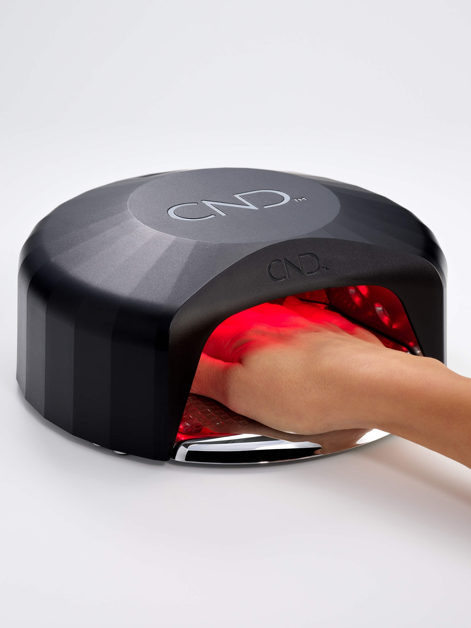 CND Visible Light Nail Lamp with purple LED hangs on a white background.